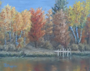 Red Oak Reflection is an 8 inch by 10 inch original oil painting on canvas of trees with vibrant autumn foliage along a quiet lakeshore.