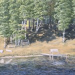 Yellow Cabin 16” x 20” original oil painting on canvas of a yellow lake cabin on a hill overlooking a lake with a dock with a bench near the end and on shore are a glider bench, a wooden swing, and two paddle boards.